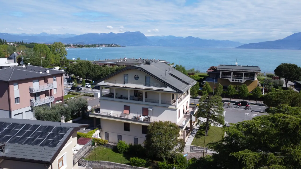 Three-level building with garden and lake view