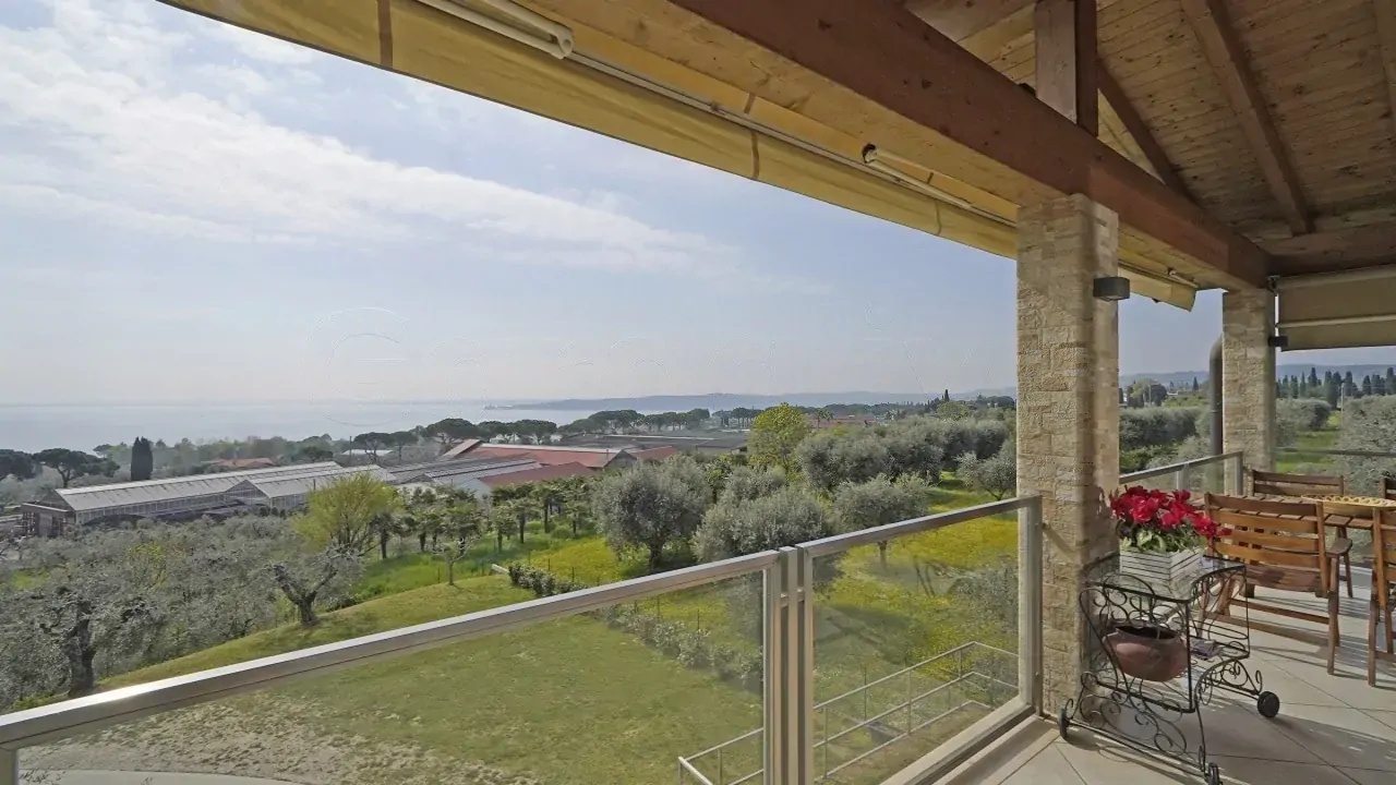 Terrazza coperta con vista sul giardino e sul lago