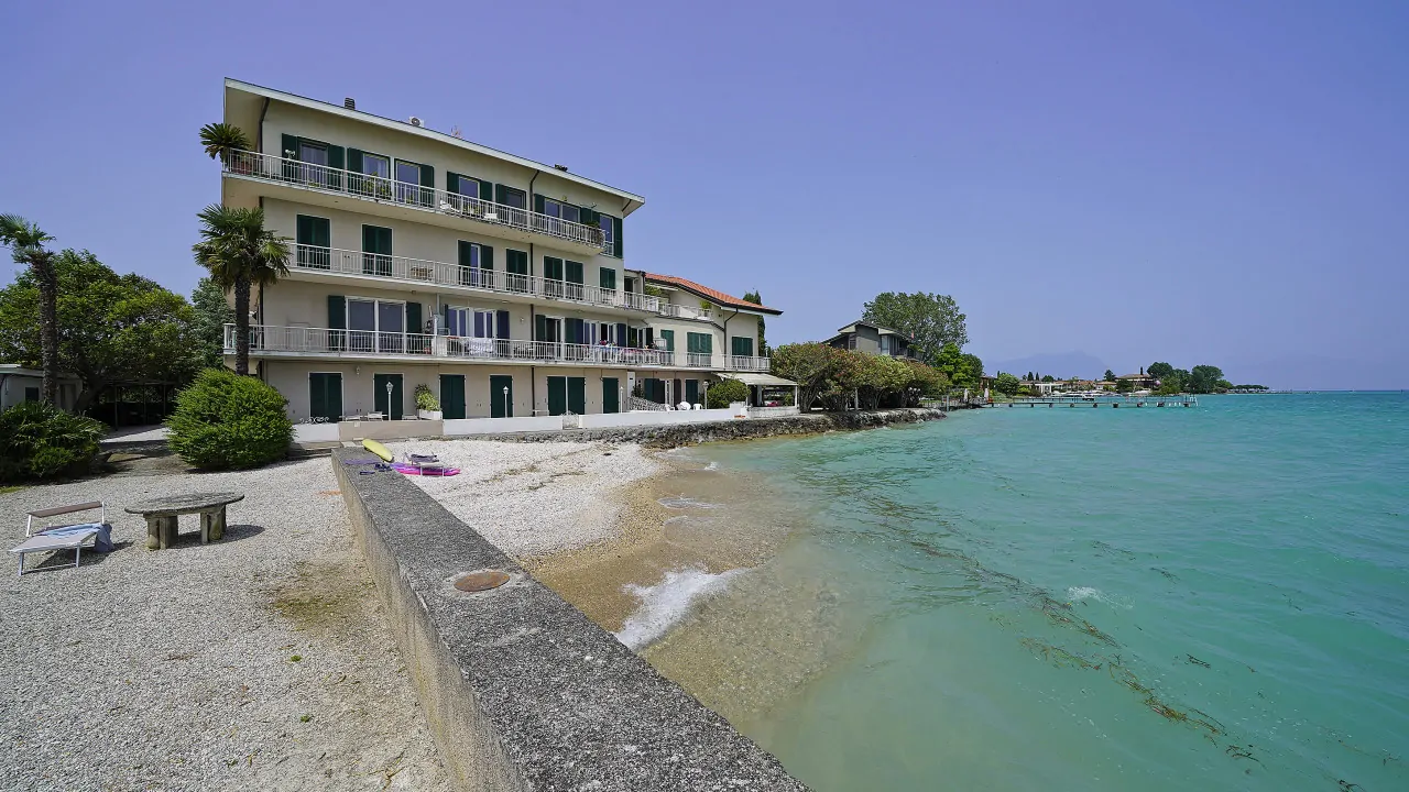 Exterior of the building with beach and lake