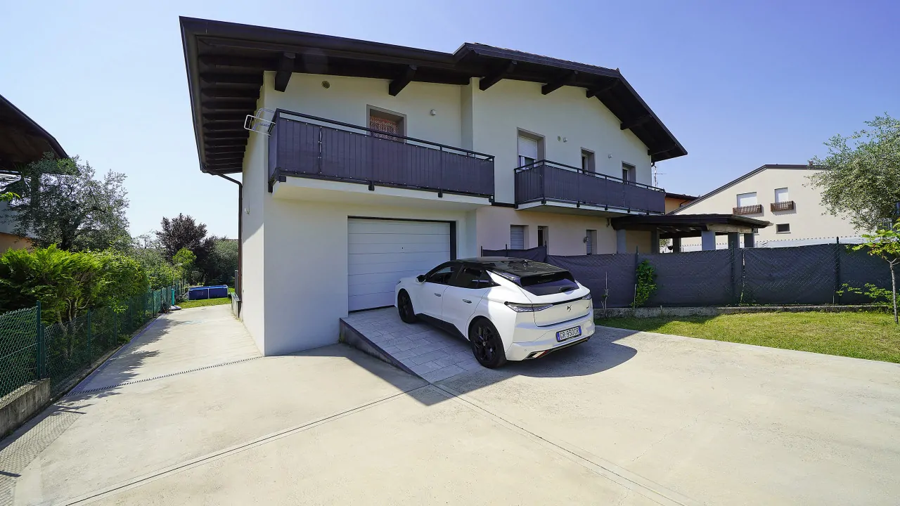 Exterior of the semi-detached house with white car in driveway
