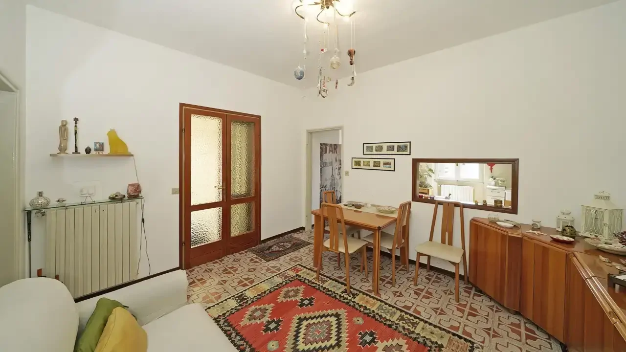 Living room with table, chairs, and white sofa