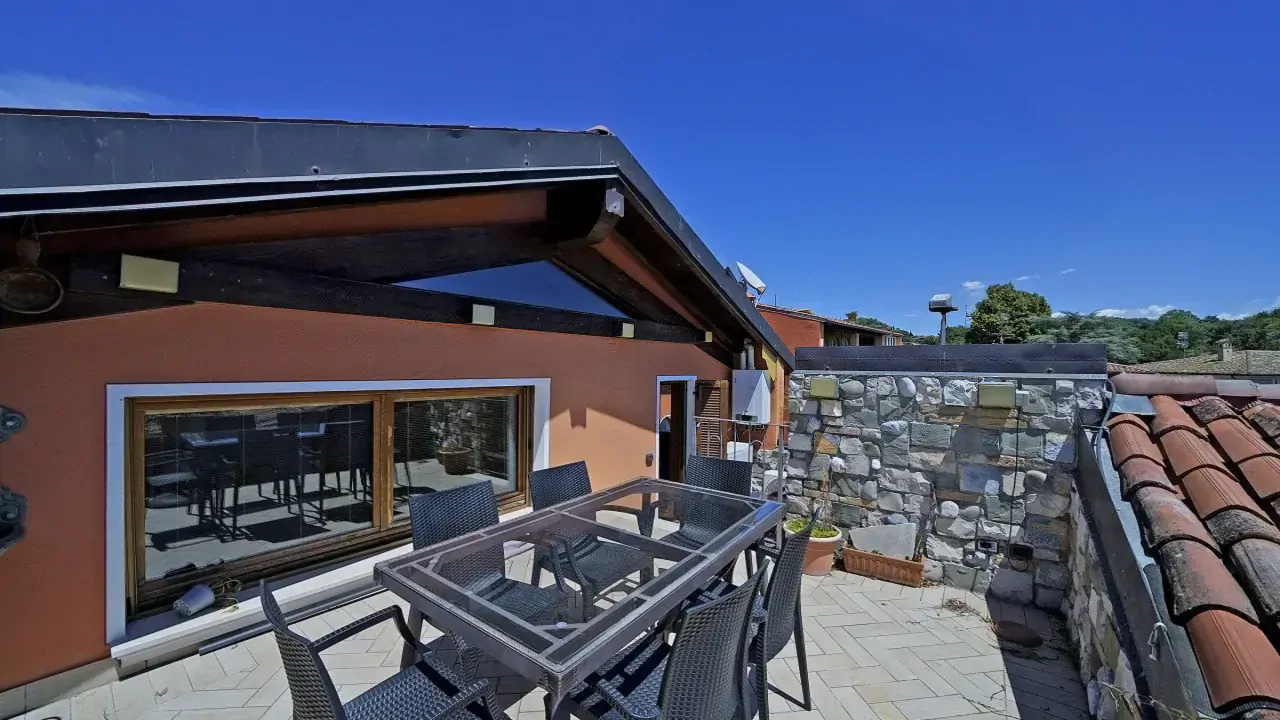 Terrace with table and chairs under blue sky