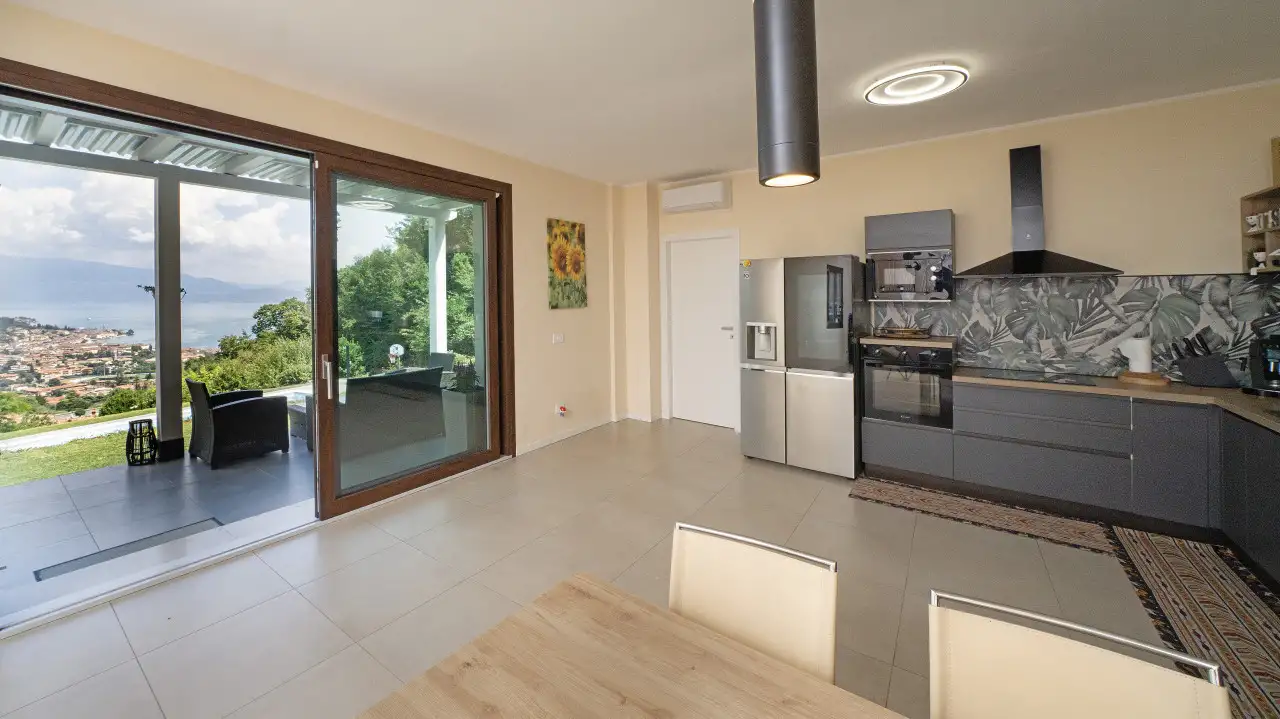 Modern kitchen with large sliding glass door and lake view