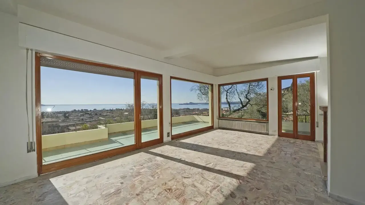 Living room with large windows and lake view