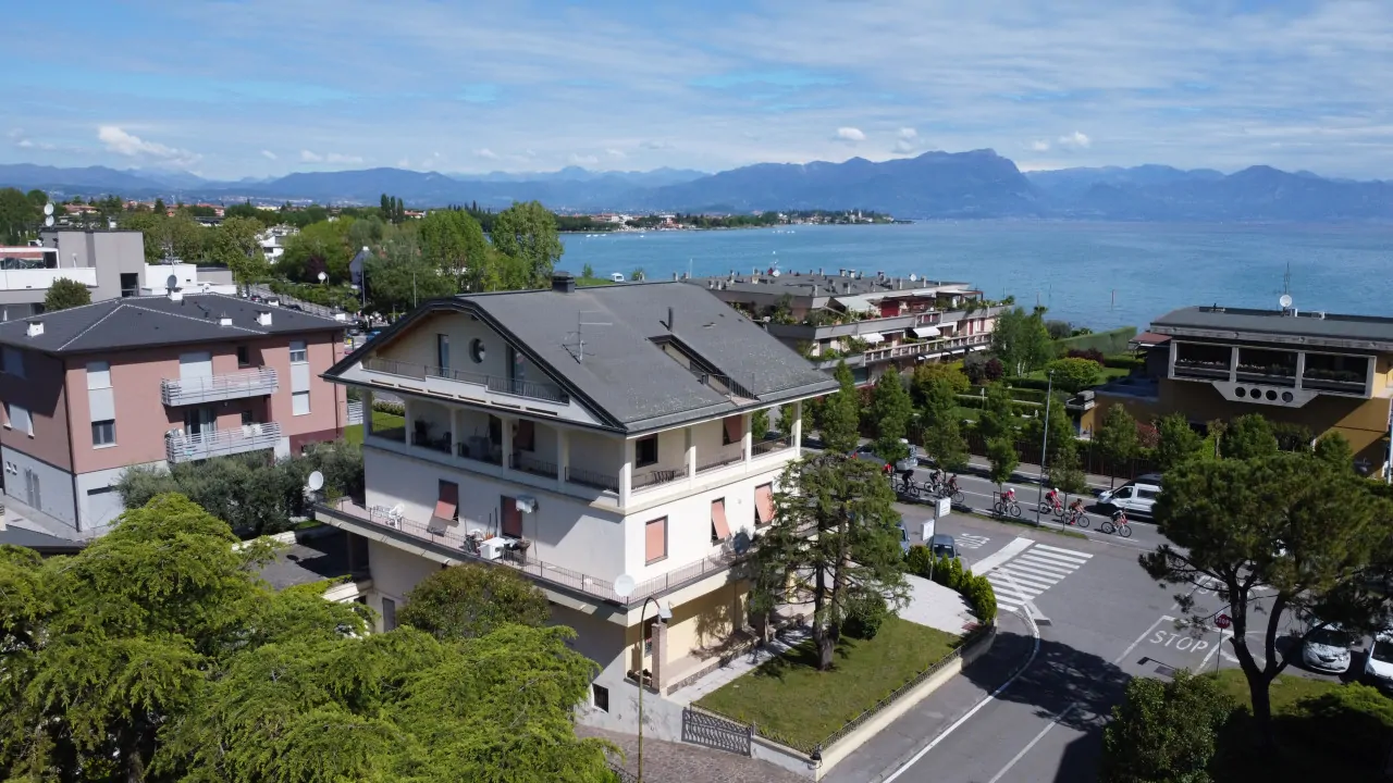 Three-level building with garden and lake view