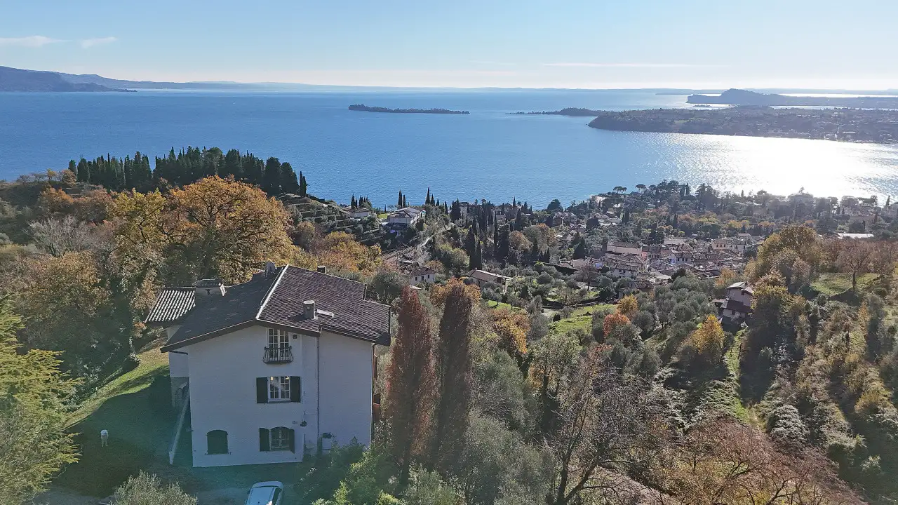 Luftaufnahme der Einzelvilla mit See im Hintergrund