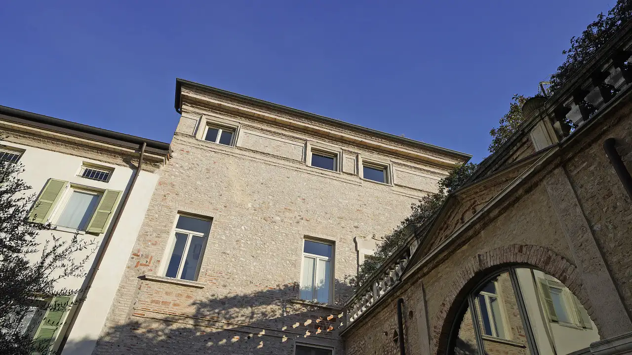 Steinfassade eines historischen Gebäudes mit Fenstern