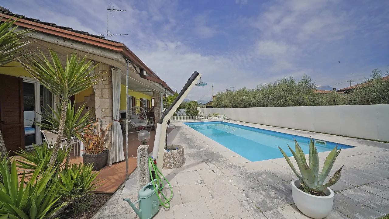 Rectangular pool with stone border and outdoor shower