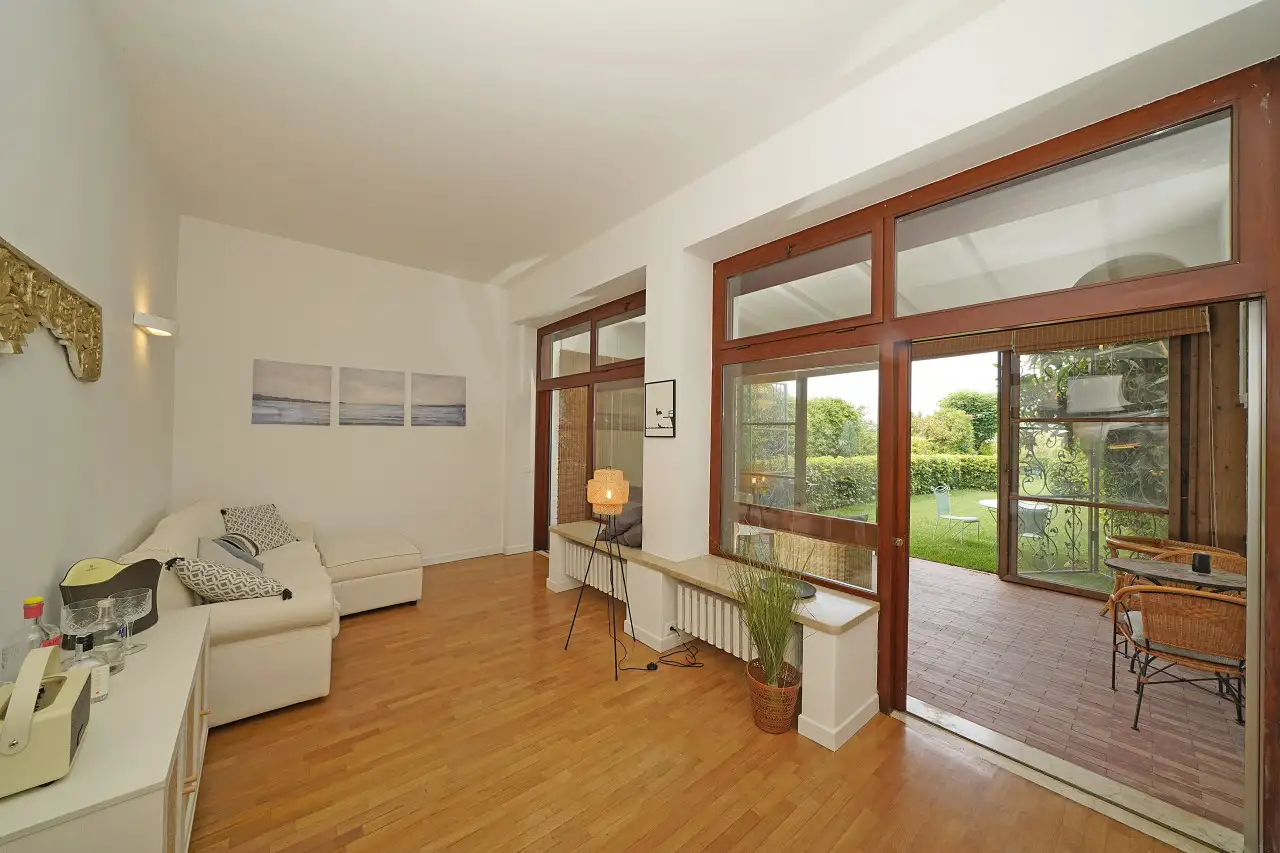 Living room with sofa and glass doors opening to garden