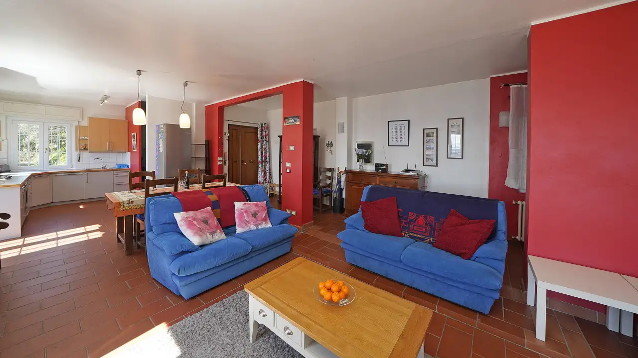 Soggiorno con divani blu e pareti rosse