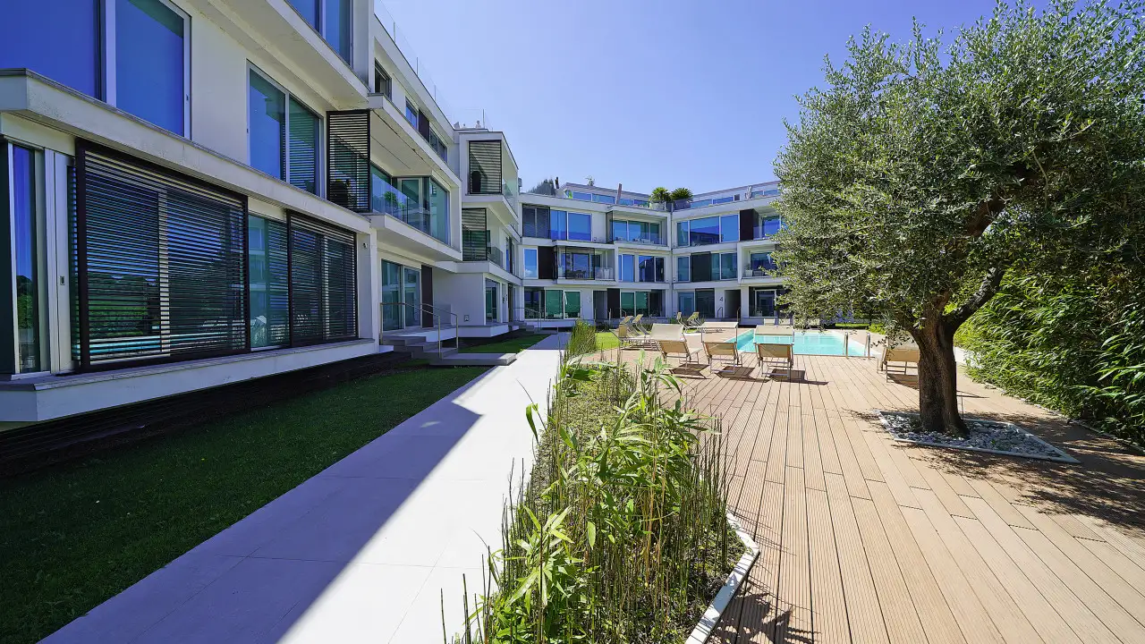 Exterior with pool and sunbathing area in modern complex
