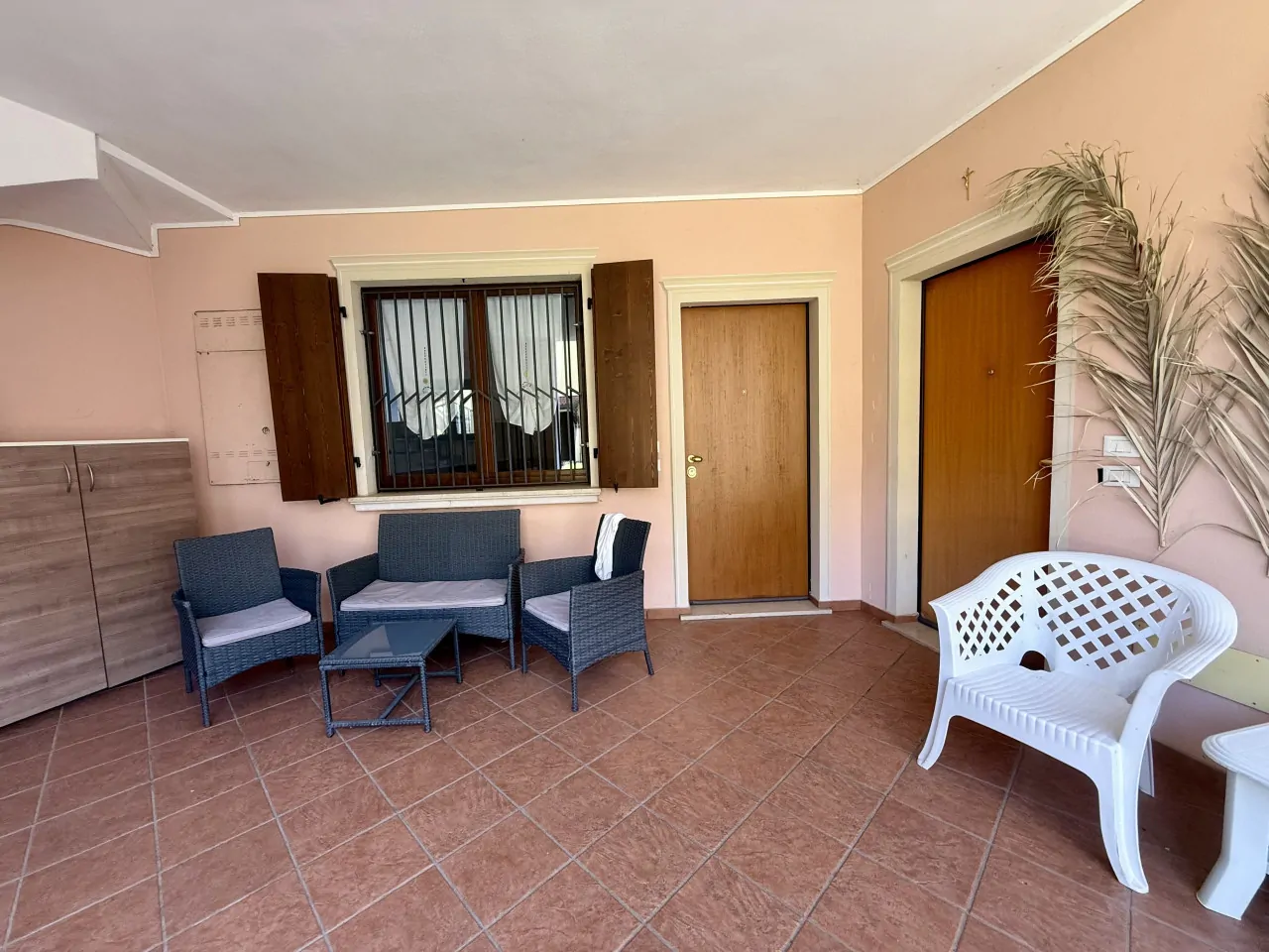 Porch with seating and two wooden doors