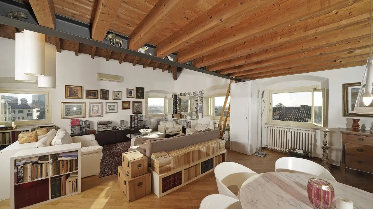 Living room with exposed beams and open windows