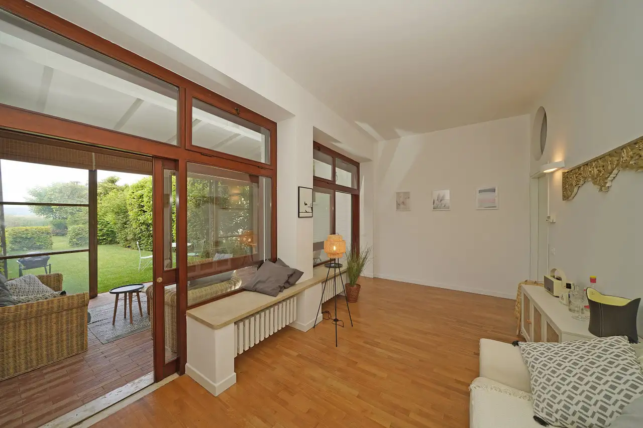 Living room with wooden French doors and access to garden