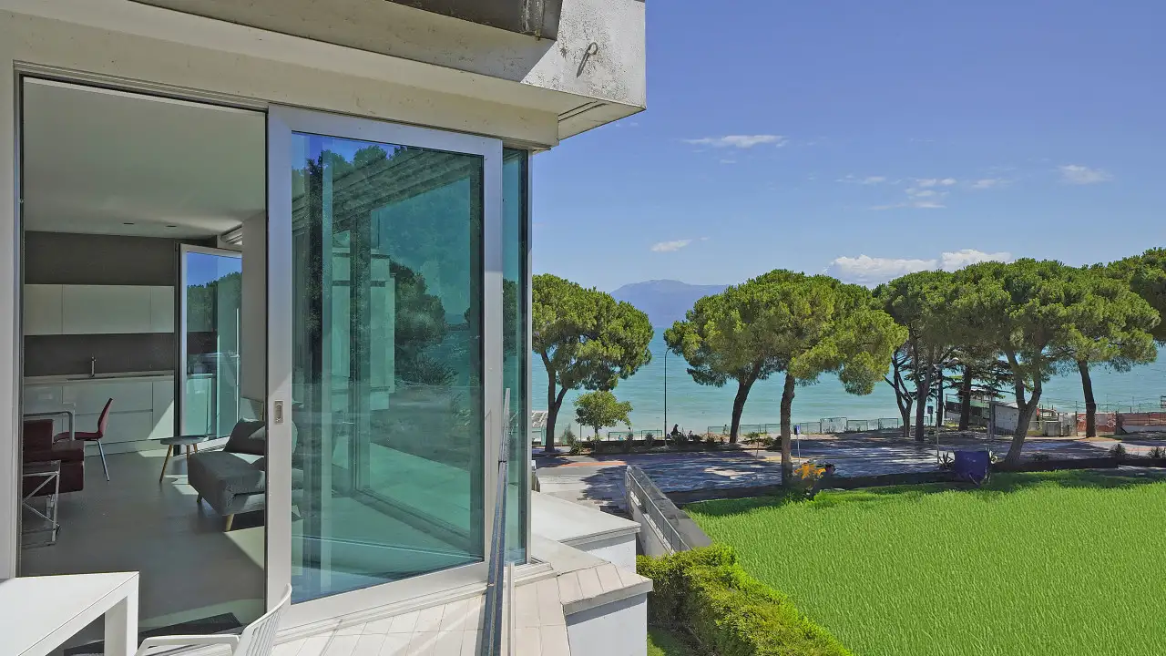 Exterior view with garden and trees towards the lake