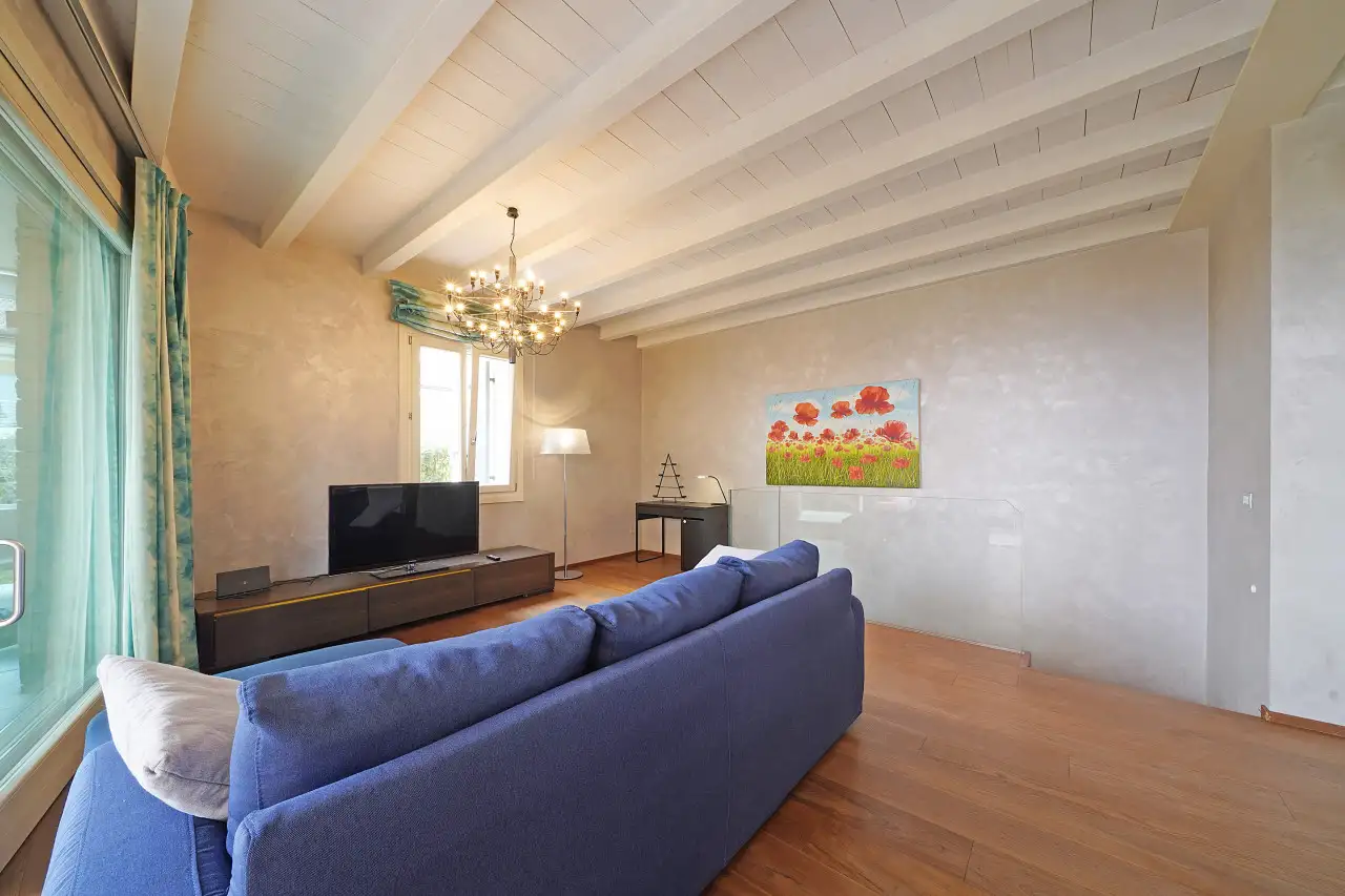 Living room with blue sofa and ceiling chandelier