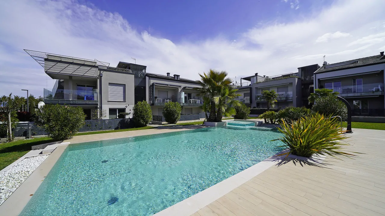 Outdoor pool with clear water and palm trees around
