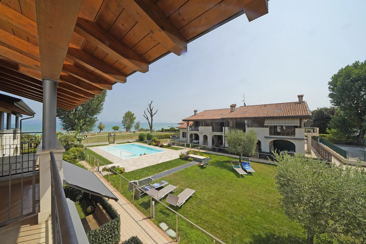 Garden with pool and lake view from covered balcony