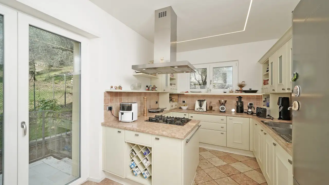 Kitchen with central island and glass door to outside
