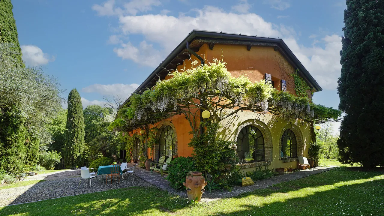 Villa storica con pergolato fiorito e giardino privato